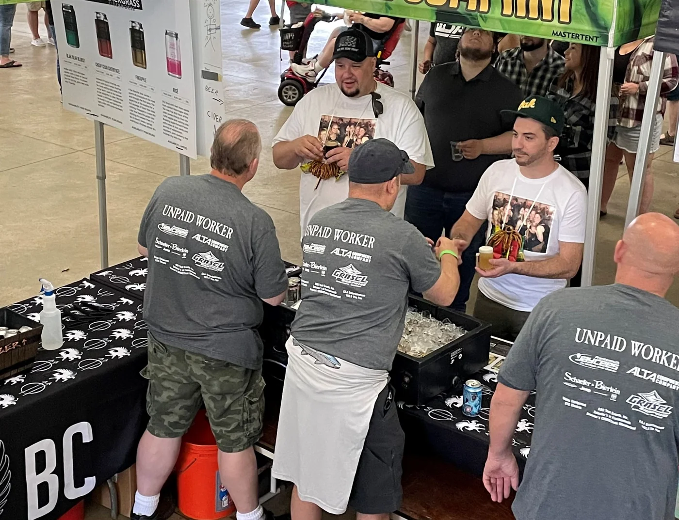 Festival volunteers serving samples to guests at a tasting booth